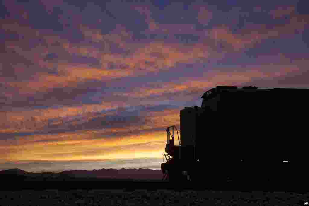 The lead locomotive of a Union Pacific freight train waits on a siding shortly before sunrise, in Sahuarita, Arizona.