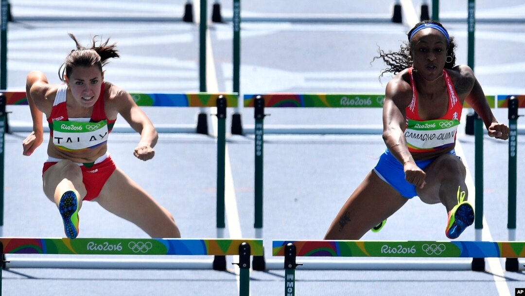 Puerto Rico's Jasmine Camacho-Quinn, right, and Belarus' Alina Talay compete in a women's 100-meter heat during the athletics competitions of the 2016 Summer Olympics at the Olympic stadium in Rio de Janeiro, Brazil, Tuesday, Aug. 16, 2016.