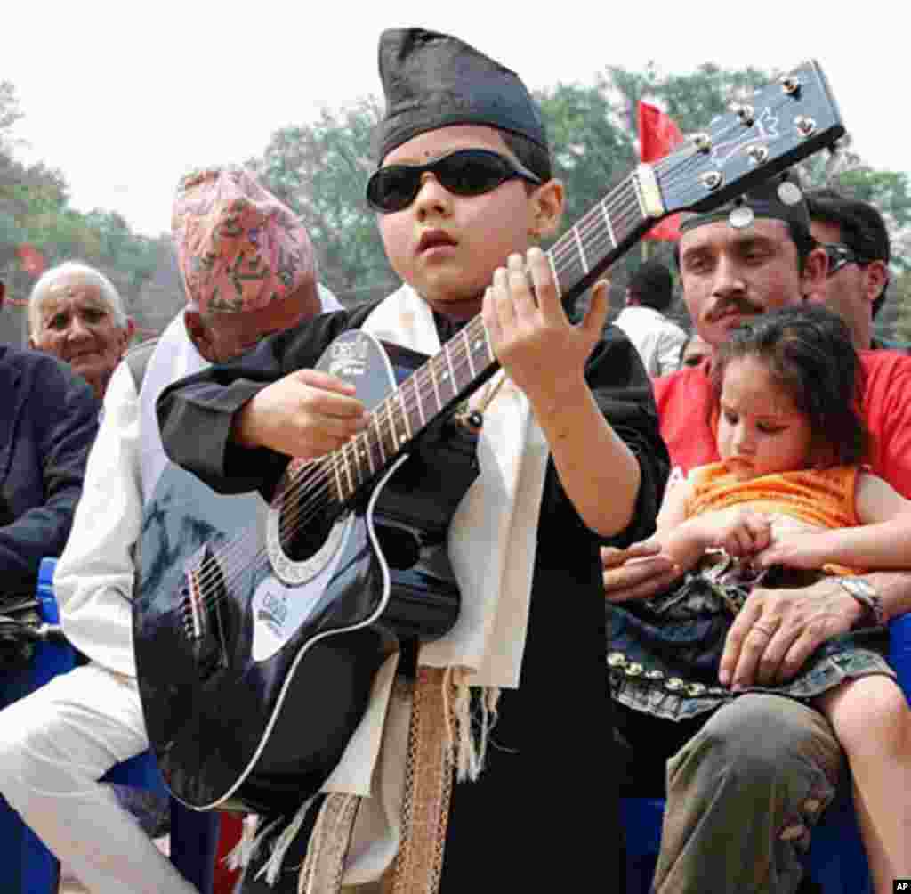A young Nepali boy and his guitar at the May Day Rally