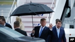 U.S. President Donald Trump waves toward the media after arriving at the Osaka International Airport to attend the G-20 Summit Thursday, June 27, 2019, in Osaka, Japan. Trump is in Osaka to attend the G20 summit. (AP Photo/Jae C. Hong)