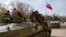Combat vehicles with a Russian flag on one of them and gunmen on top are parked in downtown of Slovyansk, Ukraine, April 16, 2014.