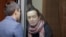 FILE - Russian-American journalist for Radio Free Europe/Radio Liberty Alsu Kurmasheva, who is in custody after she was accused of violating Russia's law on foreign agents, listens to a lawyer at a court hearing in Kazan, Russia, Dec. 1, 2023.
