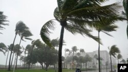 A normally bustling Ocean Drive is shown during a downpour, Sunday, Nov. 8, 2020, on Miami Beach, Florida's famed South Beach. A strengthening Tropical Storm Eta cut across Cuba on Sunday, and forecasters say it's likely to be a hurricane before…