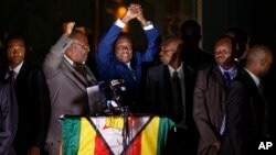 FILE: Zimbabwe's President in waiting Emmerson Mnangagwa, greets supporters gathered outside the Zanu-PF party headquarters in Harare, Zimbabwe, Nov. 22, 2017. 