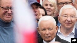 The leader of Poland's right-wing opposition party Law and Justice, Jaroslaw Kaczynski, front, attends the party's protest rally of a few thousand backers against the policies of Prime Minister Donald Tusk before the Ministry of Justice in Warsaw on Sept. 14, 2024.