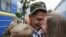 A serviceman of the 44th Artillery Brigade embraces his wife and child at a railway station in Kyiv after returning from the front line in the Eastern regions of Ukraine.