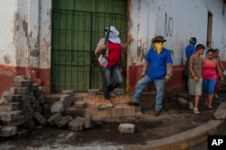 Sandinista militias stand guard at a torn-down barricade after police and pro-government militias stormed the Monimbo neighborhood of Masaya, Nicaragua, July 17, 2018.