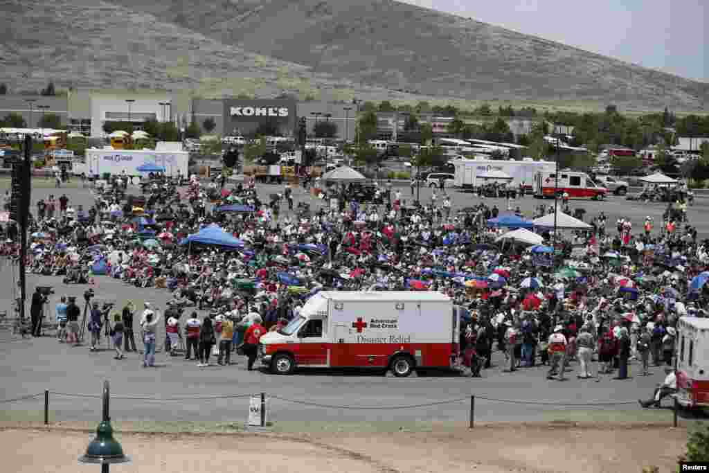 People watch a memorial service for the fallen members of the Granite Mountain Hotshots on a big screen outside the memorial arena, in Prescott Valley, Arizona, July 9, 2013.&nbsp;