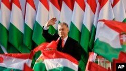 Prime Minister Viktor Orban's waves during the final electoral rally of his Fidesz party in Szekesfehervar, Hungary, April 6, 2018. Hungarians will vote Sunday in parliamentary elections, polls expect Orban to win a third consecutive term.