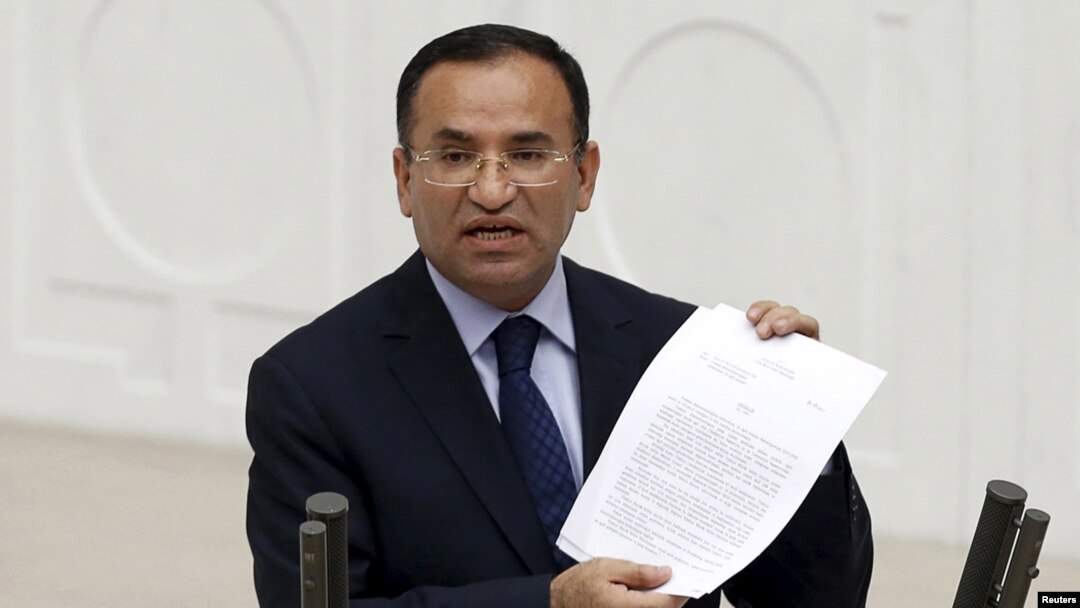 FILE - Turkish Deputy Prime Minister Bekir Bozdag, justice minister at the time, addresses Turkish lawmakers in Ankara, Turkey, March 19, 2014. Bozdag said Paris offering to mediate between Ankara and the YPG Syrian Kurdish militia amounted to supporting terrorism.