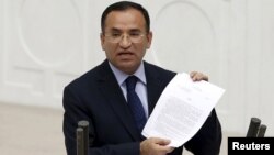 FILE - Turkish Deputy Prime Minister Bekir Bozdag, justice minister at the time, addresses Turkish lawmakers in Ankara, Turkey, March 19, 2014.