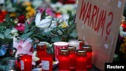 A placard reading "Why?" is placed at the Christmas market in Berlin, Germany, Dec. 20, 2016, one day after a truck ploughed into a crowded Christmas market in the German capital. 