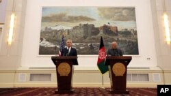 U.S. Defense Secretary Chuck Hagel left, and Afghan President Ashraf Ghani, right, speaks during a joint news conference in Kabul, Afghanistan, Saturday, Dec. 6, 2014.