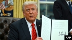 FILE - U.S. President Donald Trump signs an executive order at the White House on Feb. 10, 2025, in Washington. Trump signed another order on Feb. 20 intended to end federal benefits for people in the United States illegally.