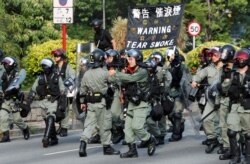 Riot police officers patrol Tai Po district during an anti-government protest in Hong Kong, China, Oct. 13, 2019.