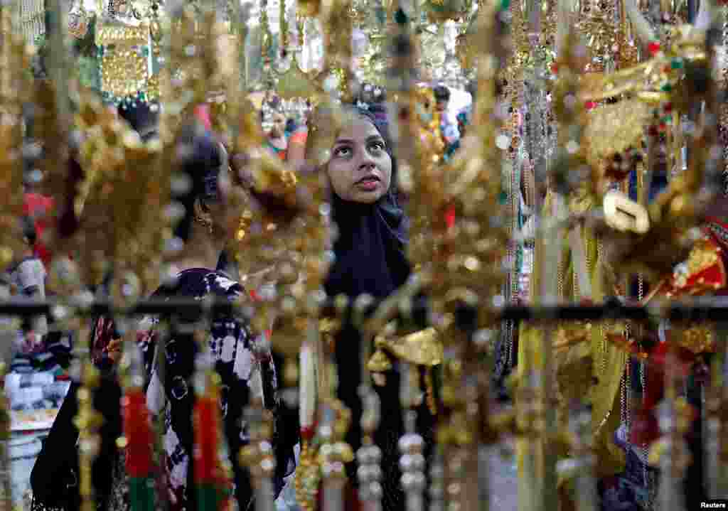 Women buy artificial jewelry and decorative items at a market ahead of Diwali, the Hindu festival of lights, in Ahmedabad, India.