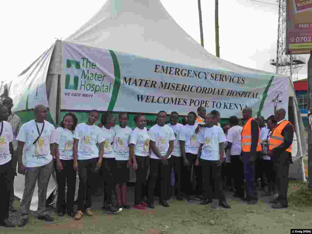 Staffers from the Mater Hospital are seen at a highway junction in Nairobi between the airport and State House, where Pope Francis is headed, Nov. 25, 2015.