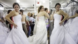 Women shop for wedding dresses during the "Running of the Brides" at Filene's Basement in New York. The yearly event offers hundreds of bridal gowns at reduced prices.