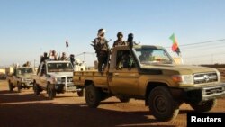 Soldiers from the Tuareg rebel group MNLA drive in a convoy of pickup trucks in the northeastern town of Kidal, Mali, Feb. 4, 2013. 