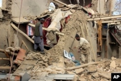 Afghan villagers gather their properties a day after the clashes between Taliban and Afghan security forces in Taliban's controlled village, Buz-e Kandahari village in Kunduz province, north of Kabul, Afghanistan, Friday, Nov. 4, 2016.