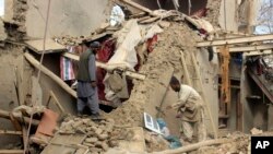 FILE - Afghan villagers gather their properties a day after clashes between Taliban and Afghan security forces in Taliban-controlled Buz-e Kandahari village in Kunduz province, Afghanistan, Friday, Nov. 4, 2016. 