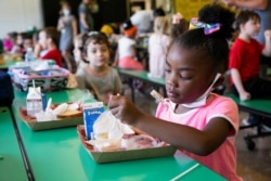 A student eats her school lunch at Wilder Elementary School in Louisville, Kentucky, August 11, 2021.