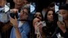 People take photos of the iPhone 15 Pro phones during an announcement of new products on the Apple campus in Cupertino, Calif., Sept. 12, 2023. 