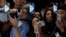 People take photos of the iPhone 15 Pro phones during an announcement of new products on the Apple campus in Cupertino, Calif., Sept. 12, 2023. 
