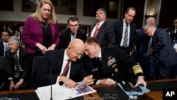 Director of National Intelligence James Clapper (L) talks with National Security Agency and Cyber Command chief Adm. Michael Rogers on Capitol Hill in Washington, Jan. 5, 2017, after a Senate Armed Services Committee hearing: "Foreign Cyber Threats to the United States." 