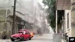 An image grab taken from a video posted on YouTube shows a police car burning during an anti-regime protest in the central city of Homs, May 20, 2011