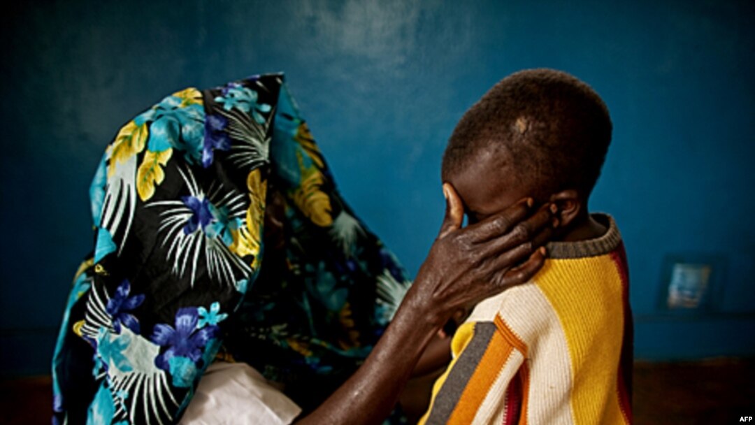 A mass rape victim comforts her son in the town of Fizi, Democratic Republic of Congo, February 20, 2011
