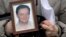 Nataliya Magnitskaya holds a portrait of her son Sergei Magnitsky, a lawyer who died in jail, Moscow, Nov. 30, 2009.