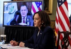 U.S. Vice President Kamala Harris takes notes as she speaks via videoconference with Guatemala's President Alejandro Giammattei to discuss solutions to an increase in migration as she looks for ways to defuse a migrant crisis at the U.S. border