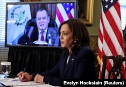 U.S. Vice President Kamala Harris takes notes as she speaks via videoconference with Guatemala's President Alejandro Giammattei to discuss solutions to an increase in migration as she looks for ways to defuse a migrant crisis at the U.S. border