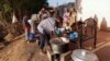 Displaced Sudanese families wait to receive food from a charity kitchen, as a year of war between Sudan's army and the paramilitary Rapid Support Forces (RSF) has driven more than 8.5 million people from their homes, in the city of Omdurman, Sudan, April 6, 2024. 