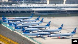 FILE - China Southern Airlines Boeing 737 Max airplanes are parked at the edge of the tarmac at Urumqi Diwopu Interational Airport in Urumqi, China, April 21, 2021. 