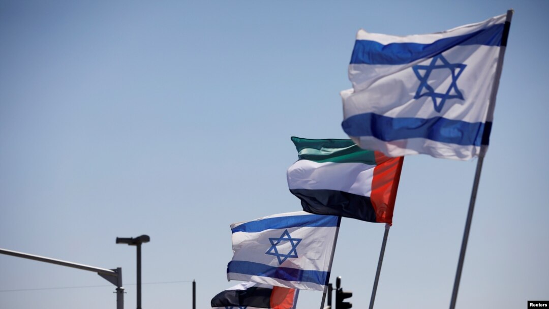 FILE - The national flags of Israel and the United Arab Emirates flutter along a highway following the agreement to formalize ties between the two countries, in Netanya, Israel, Aug. 17, 2020. 