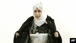 FILE - Iraqi Sajida Mubarek Atrous al-Rishawi opening her jacket and showing an explosive belt as she confesses on Jordanian state-run television to her failed bid to set off a bomb inside one of three Amman hotels targeted by al-Qaida in Jordan, Nov. 13, 2005.