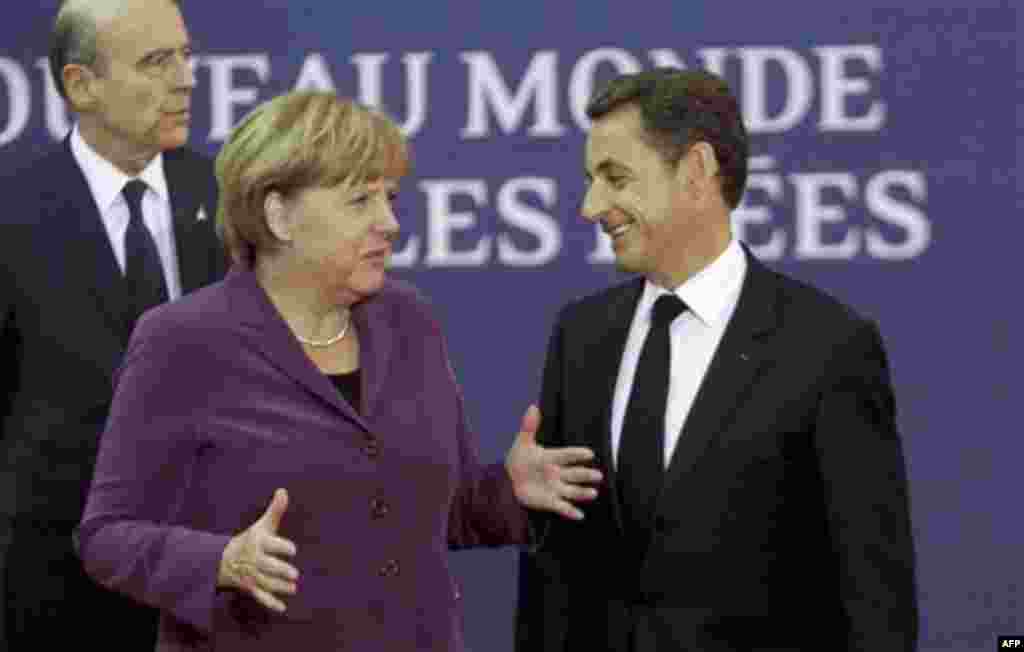 RETRANSMISSION TO IMPROVE TONING - French President Nicolas Sarkozy, right, speaks with German Chancellor Angela Merkel as they arrive for the G20 summit in Cannes, France on Wednesday, Nov. 2, 2011. Greek Prime Minister George Papandreou was flying to th