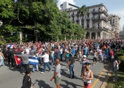 Demonstrators clash during protests against and in support of the government, in Havana, July 12, 2021.