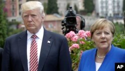 FILE - U.S. President Donald Trump and German Chancellor Angela Merkel are pictured at the G-7 meeting in Taormina, Italy, May 26, 2017. 