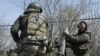 FILE - Belarusian volunteer soldiers from the Kastus Kalinouski Regiment prepare a 120 mm mortar at a front-line position near Bakhmut in the Donetsk region, on April 9, 2023, amid the Russian invasion of Ukraine.