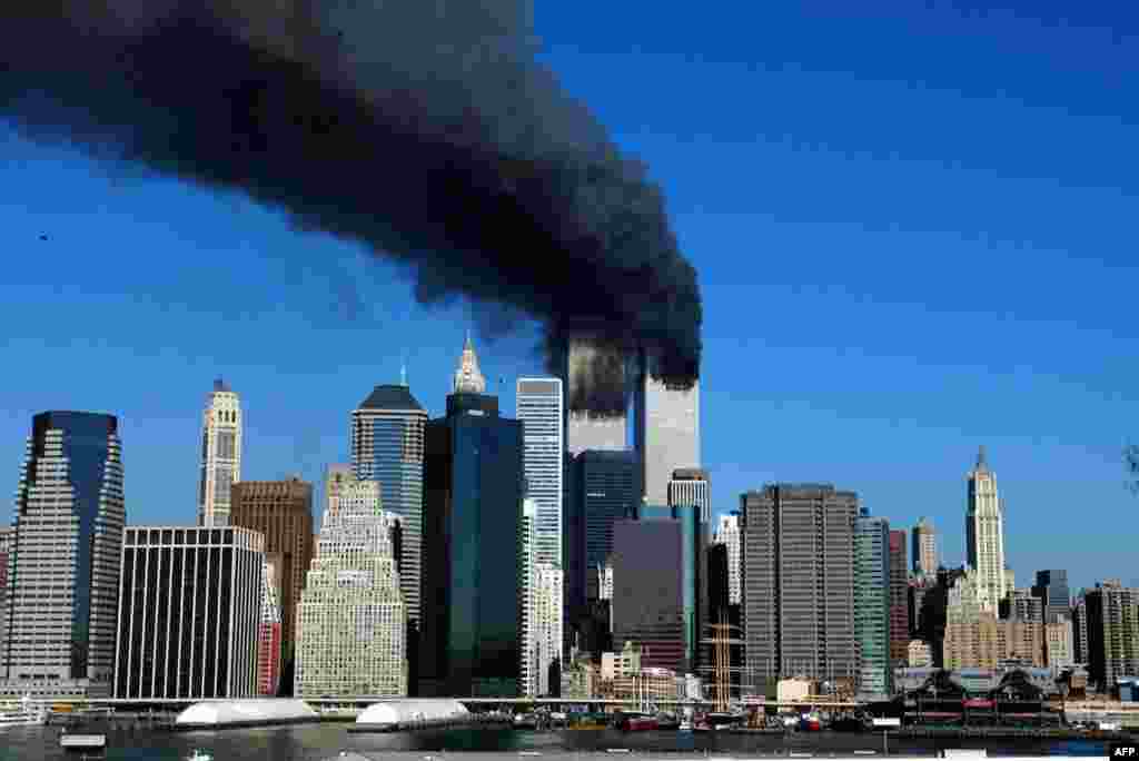 (FILE) The twin towers of the World Trade Center billow smoke after hijacked airliners crashed into them early 11 September, 2001. The suspected terrorist attack has caused the collapsed of both towers. AFP PHOTO/Henny Ray ABRAMS (Photo by HENNY RAY ABRAMS / AFP)