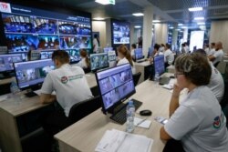 Observers watch a live broadcast from polling stations at the Moscow Public Election Monitoring Center during the second day of a three-day long vote in parliamentary elections in Moscow, Russia. Sept. 18, 2021.