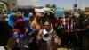 Sudanese demonstrators rally near the military headquarters in the capital Khartoum, April 16, 2019. Protesters toughened their stance Tuesday by calling for the dissolution of the transitional military council, to be replaced immediately with a civilian power.