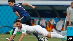 Poland's Bartosz Bereszynski, front, is challenged by Japan's Gaku Shibasaki during the group H match between Japan and Poland at the 2018 soccer World Cup at the Volgograd Arena in Volgograd, Russia, June 28, 2018.