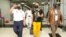 Cuban journalists Hector Valdez and Esteban Rodriguez, both reporters with the independent news website ADN Cuba, walk out of El Salvador International Airport upon their arrival in El Salvador, in San Luis Talpa, Jan. 5, 2022. 