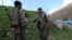 Kurdistan Workers Party (PKK) fighters talk to each other as they stand guard at the Qandil mountains near the Iraq-Turkish border in Sulaimaniya, 330 kilometers northeast of Baghdad, Iraq, March 24, 2013.