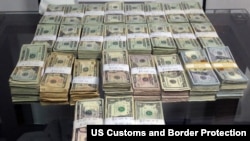 This 2014 U.S. Customs and Border Protection photo shows $189,300 in unreported U.S. currency seized from a Mexican man who attempted to smuggle the cash into the United States.