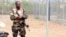 A member of the security forces stands guard at the airport as Ivory Coast Minister of Defense Alain-Richard Donwahi arrives to speak with mutinous soldiers in Bouake, Ivory Coast, Jan. 13, 2017.